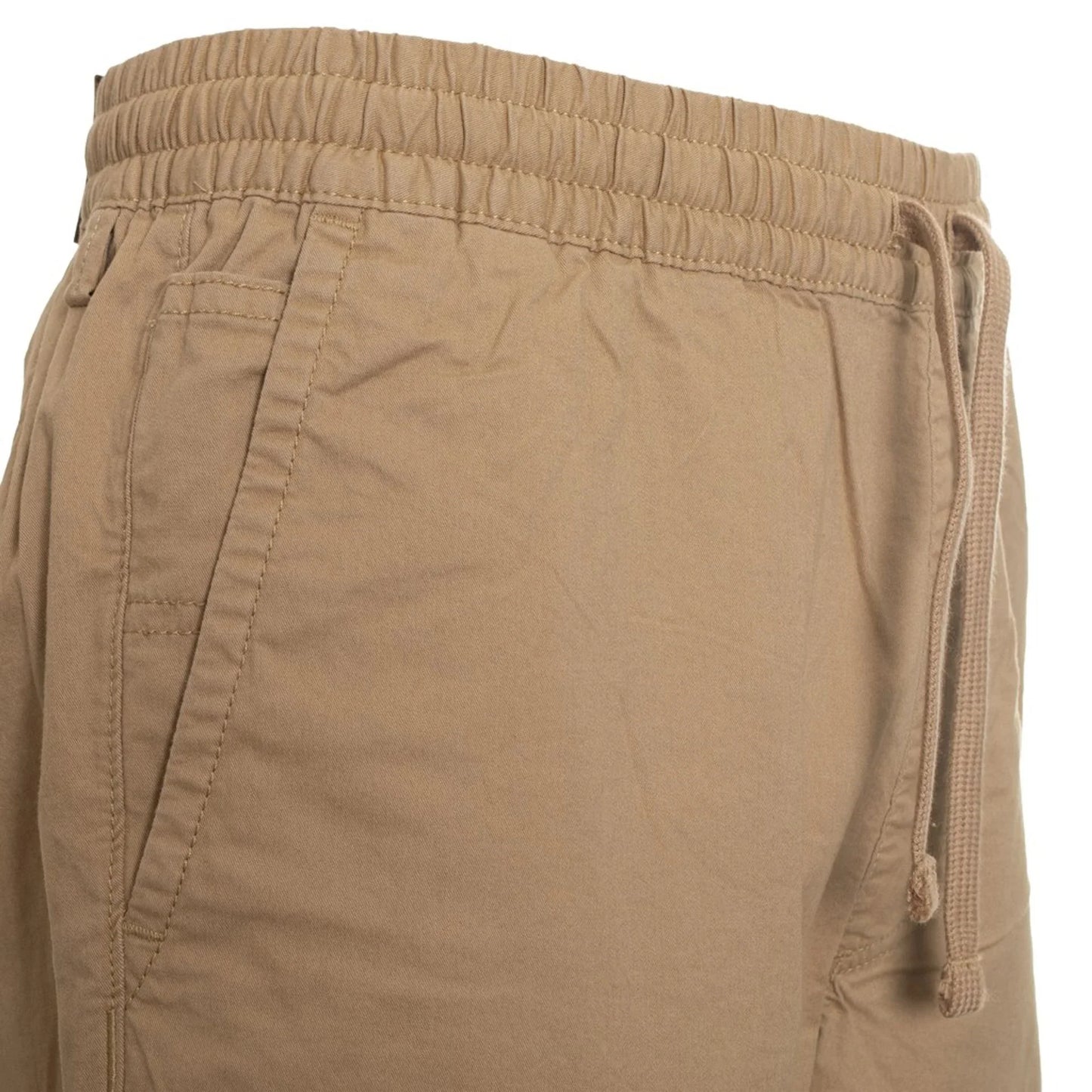 Close-up of men's tan Vans pants with elastic waistband, drawstring, and visible logo detail made of cotton blend fabric.
